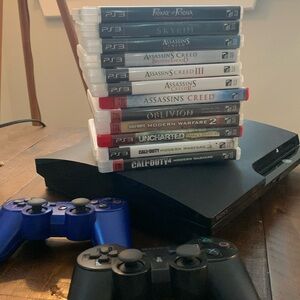 PlayStation 3 with games and controllers PS3 slim